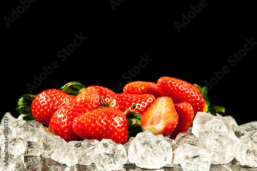Photo: strawberry on black background. strawberries with ice cubes on strawberry on black background. strawberries with ice cubes on