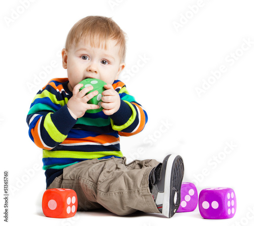 Photo: baby is playing with toys over white background. Funny little k baby is playing with toys over white background. Funny little k