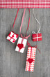 Liebevolle Weihnachtskarte mit Geschenken in Rot auf Holz