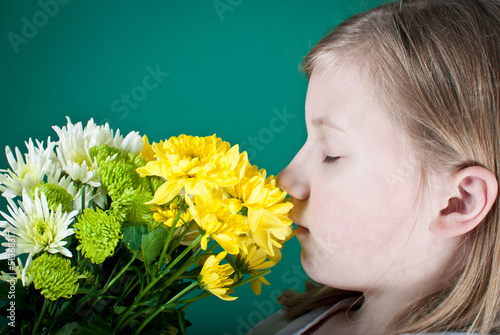 Photo: Girl smelling flowers Girl smelling flowers