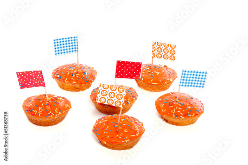 Photo: Queensday cake with flags and speckles isolated on white backgro Queensday cake with flags and speckles isolated on white backgro