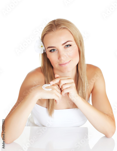 Photo: Cute girl applying hand cream Cute girl applying hand cream