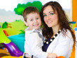Portrait of woman and little boy in playroom