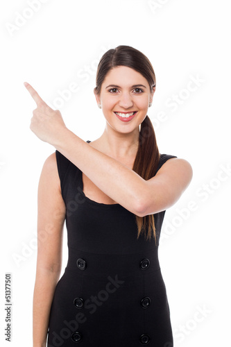 Photo: Young female pointing away Young female pointing away