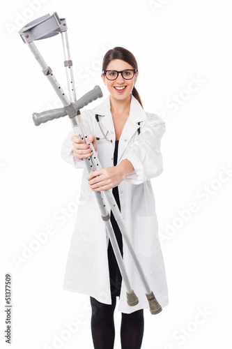Photo: Female doctor displaying a set of crutches Female doctor displaying a set of crutches