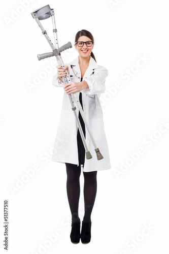 Photo: Smiling medical expert holding pair of crutches Smiling medical expert holding pair of crutches