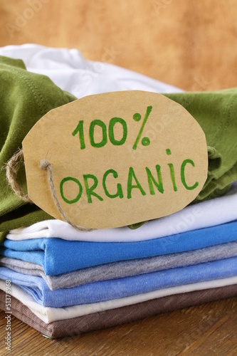 Photo: stack of multicolored clothing with organic label stack of multicolored clothing with organic label