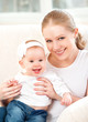 happy family. Mother and baby daughter at home on the sofa