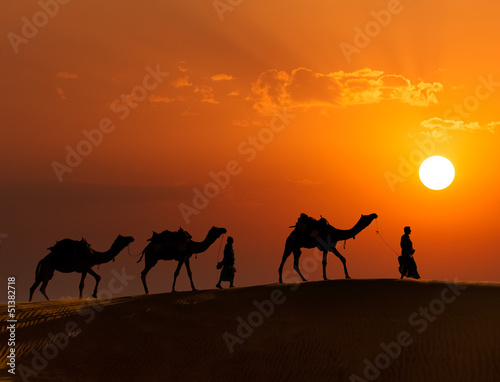 Photo: Two cameleers (camel drivers) with camels in dunes of Thar deser Two cameleers (camel drivers) with camels in dunes of Thar deser