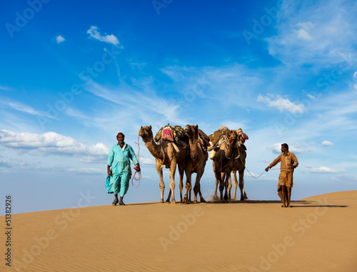Photo: Two cameleers (camel drivers) with camels in dunes of Thar deser Two cameleers (camel drivers) with camels in dunes of Thar deser