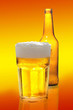bottle and glass with beer on white background