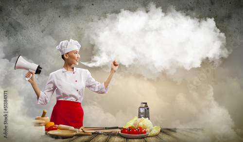 Photo: Asian female cook holding megaphone Asian female cook holding megaphone