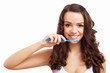 Young woman at home brushing teeth