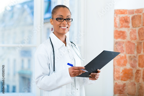 Photo: Portrait of young female doctor in clinic Portrait of young female doctor in clinic