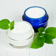 face cream in jars with urtica leaves