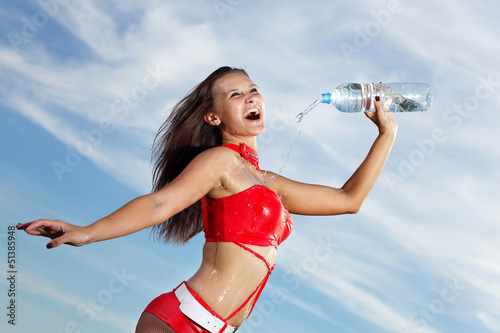 Photo: Young female sport girl with a bottle of water Young female sport girl with a bottle of water