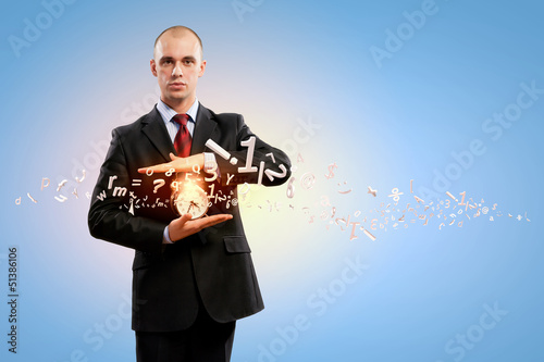 Photo: Business man holding alarmclock Business man holding alarmclock