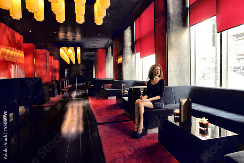 Photo: woman sitting in a lounge woman sitting in a lounge