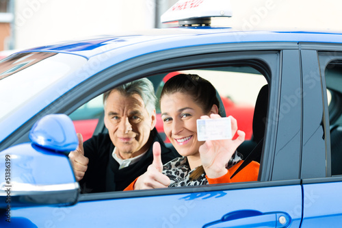 Photo: Young woman at driving lesson Young woman at driving lesson