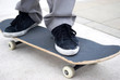 Boy's foot stepping on skateboard