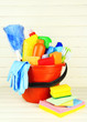 Cleaning items in bucket on  white wooden background