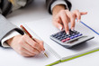 Hands working on the calculator