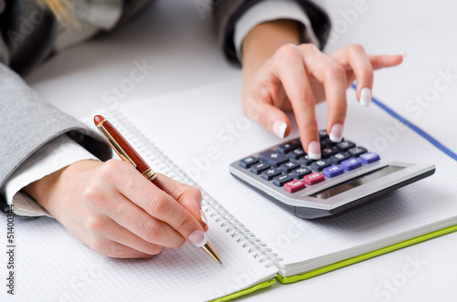 Photo: Hands working on the calculator Hands working on the calculator