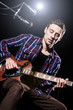Man playing guitar during concert