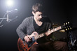 Man playing guitar during concert