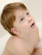 Cute boy taking a bath with foam