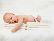 New born baby boy yawning on fur blanket