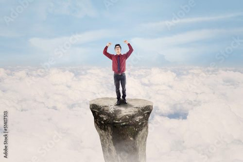 Photo: Businessman win above clouds Businessman win above clouds