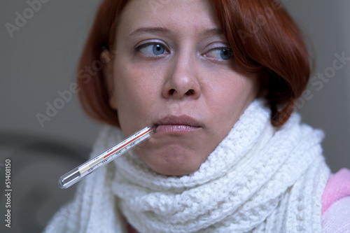 Photo: A woman with a thermometer A woman with a thermometer