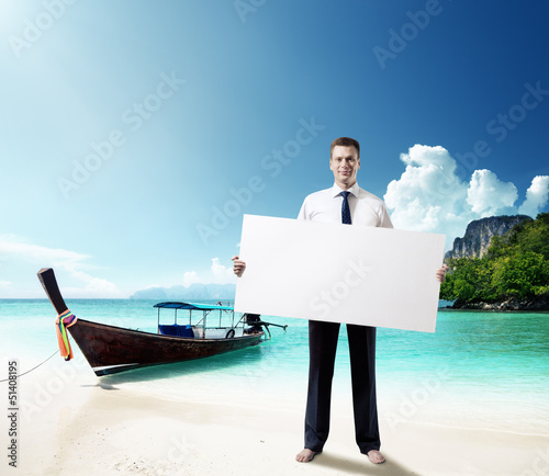 Photo: man on the beach of Thailand whith empty board in hand man on the beach of Thailand whith empty board in hand