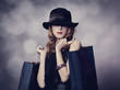 Style redhead girl with shopping bags.