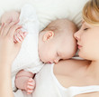 Young mother and her baby, sleeping in bed