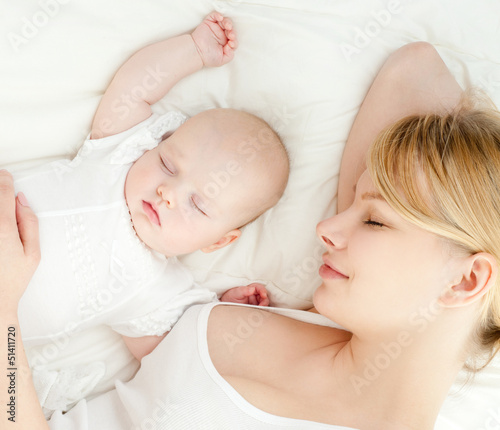 Photo: Young mother and her baby, sleeping in bed Young mother and her baby, sleeping in bed