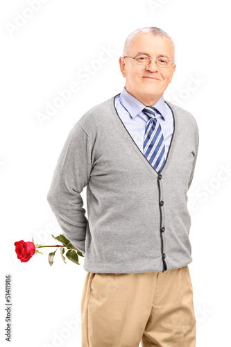 Photo: A mature smiling gentleman holding a red rose A mature smiling gentleman holding a red rose