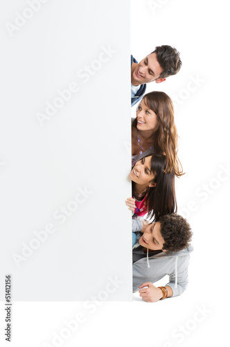 Photo: Group Of Friends Looking At Placard Group Of Friends Looking At Placard