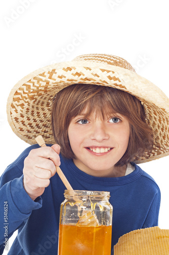 Photo: Little boy eats honey Little boy eats honey