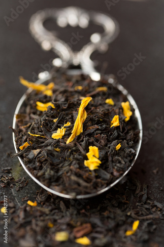 Photo: Black tea leaves with flowers on tea spoon Black tea leaves with flowers on tea spoon
