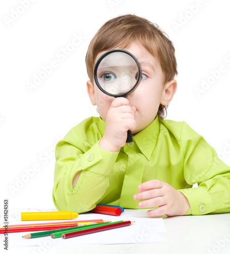 Photo: Cute little boy is playing with magnifier Cute little boy is playing with magnifier