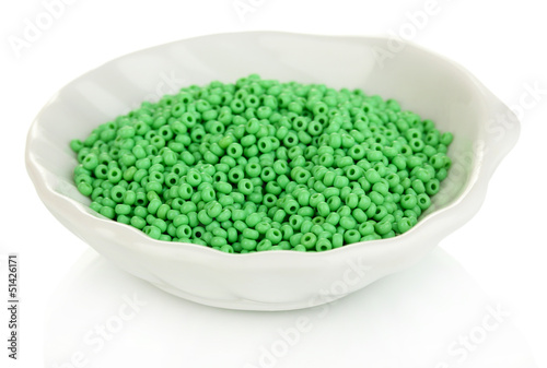 Photo: Green beads in white plate isolated on white Green beads in white plate isolated on white