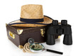 Black modern binoculars with suitcase and straw hat isolated