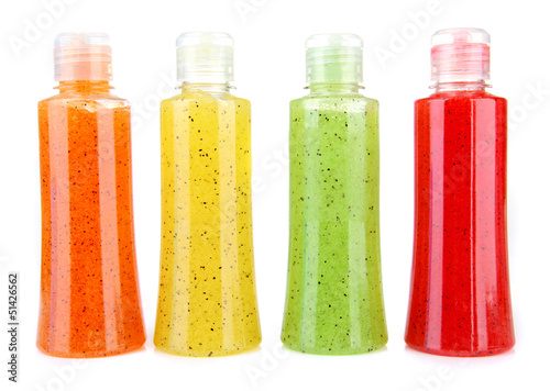 Photo: Bottles with scrub isolated on white Bottles with scrub isolated on white