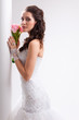 Photo: beautiful bride standing near white column beautiful bride standing near white column