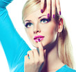 Blonde model with fashion make-up and violet manicure