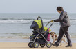 Photo: Madre con cochecito bebe por la playa Madre con cochecito bebe por la playa