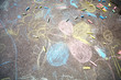 Chalk drawings, made by children on asphalt, and pieces of chalk