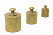 Three antique weights isolated on white